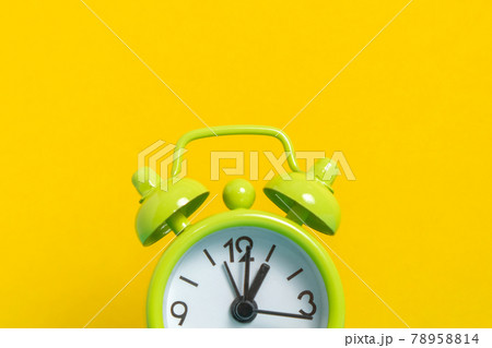 black vintage alarm clock on yellow color background 78958814