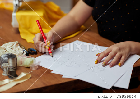 Fashion designer drawings with a pencil sketches 78959954