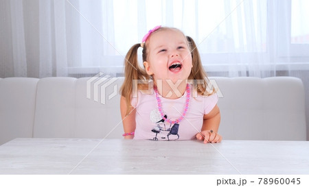 portrait of a pretty cute laughing girl 3-4 years old with big eyes and a beautiful hairstyle with a portrait of a pretty cute laughing girl 3-4 years old with big eyes and a beautiful hairstyle with a 78960045