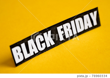 Black Friday sticker on a yellow background. Close up. Black Friday sticker on a yellow background. Close up. 78960334