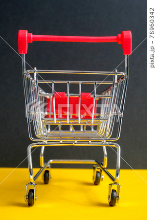 A trolley on a black background. Symbol "Black Friday". Vertical. A trolley on a black background. Symbol "Black Friday". Vertical. 78960342