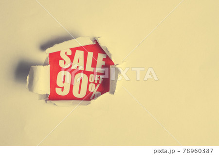 The concept of sales in the form of discounts 90. The inscription on the red paper coming out of the white paper. Toned. 78960387