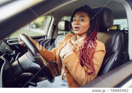 Emotional black woman sitting in a car Emotional black woman sitting in a car 78960462