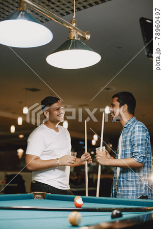 Men drink alcohol at pool table Men drink alcohol at pool table 78960497
