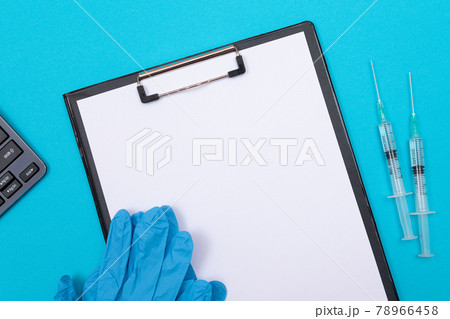 Vaccination or Revaccination Concept - Two Medical Syringe on Blue Table Vaccination or Revaccination Concept - Two Medical Syringe on Blue Table 78966458