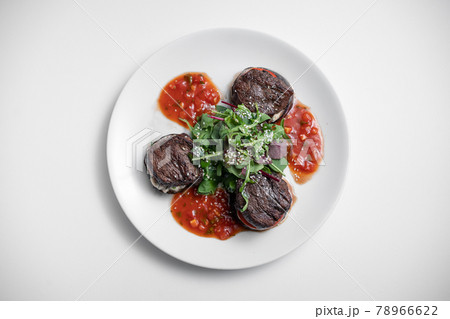 top view of meat beef medallion on tomato and grilled eggplant with salsa sauce 78966622