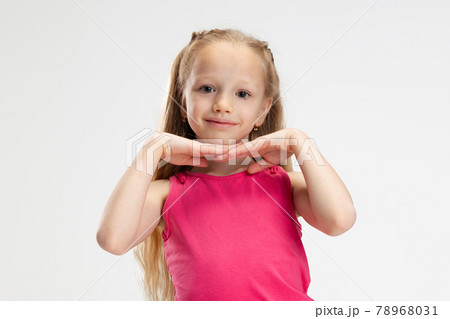 Close-up beautiful little girl in casual clothes posing isolated on white studio background. Happy childhood concept. 78968031