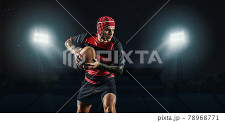 One caucasian man playing rugby on the stadium at stadium with flashlights. Cocept of sport, competition. 78968771