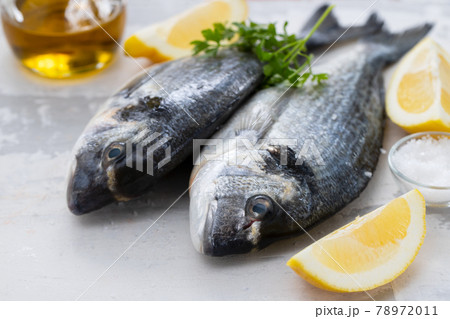raw fish with olive oil and lemon background 78972011