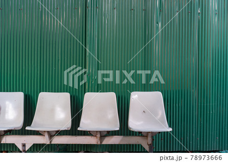 White plastic seats at temporary bus stop. White plastic seats at temporary bus stop. 78973666