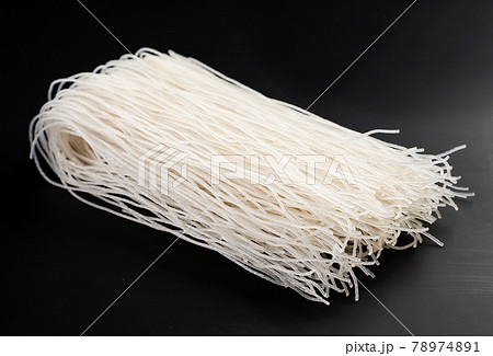 Rice vermicelli on a black background. Funchoza 78974891