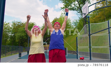 Active senior sports team athletes rising arms hands together, cheering and ready to win, smiling 78976118