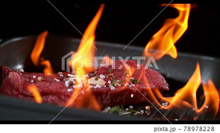 Super slowmotion footage of flambe fresh beef meat and seasoning on ignited pan, 1000fps 4k Super slowmotion footage of flambe fresh beef meat and seasoning on ignited pan, 1000fps 4k 78978228