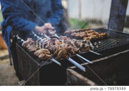 A man prepares on the grill delicious barbecue. shish kebabs on skewers 78978389