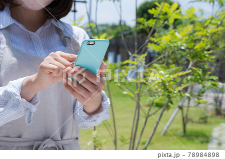 スマホを持つ女性の手元 78984898