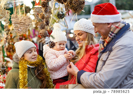 Family buying Christmas decorations Family buying Christmas decorations 78985625