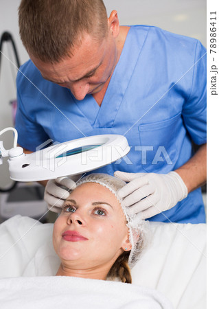 Doctor is examining woman patient before the procedure 78986411