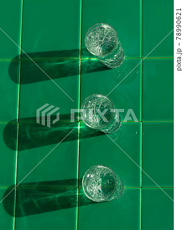 Refreshing summer drinks in crystal glasses on yellow bar tile background with harsh shadows Sweet cold natural cocktail 78990621