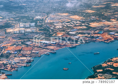Aerial view of coastal construction or port areas in Strait of Malacca, on airplane route to Malaysia or Singapore. Airplane shot Aerial view of coastal construction or port areas in Strait of Malacca, on airplane route to Malaysia or Singapore. Airplane shot 78992107
