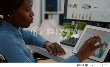 African invalid manager woman using pc and tablet in same time African invalid manager woman using pc and tablet in same time 78992422