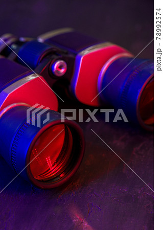 Hunting binoculars with red lense, close up Hunting binoculars with red lense, close up 78992574