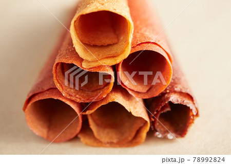 Fruit and berries lozenge different colors on table.  78992824