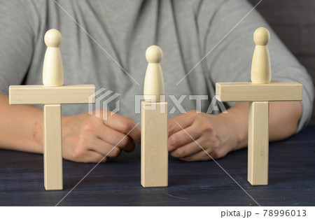 wooden figures stand on the bridge from the sides opposite each other wooden figures stand on the bridge from the sides opposite each other 78996013