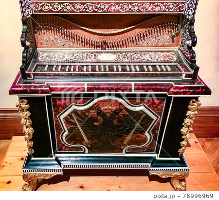ancient musical instrument, beautiful antique musical instrument with carving and coat of arms in the museum ancient musical instrument, beautiful antique musical instrument with carving and coat of arms in the museum 78996969