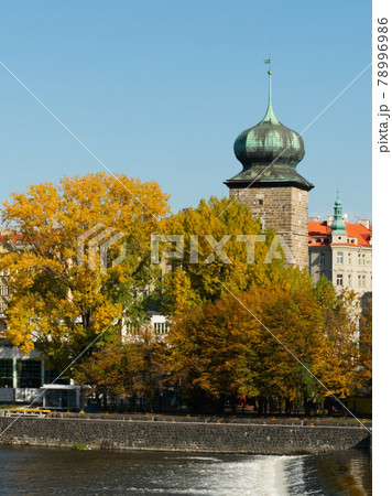 Ancient tower on the river bank in the fall. Autumn Prague. Landscape. 78996986