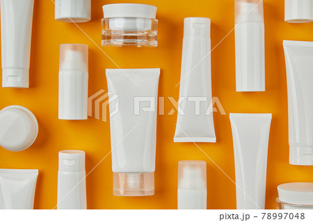 Lotion or cream set on orange background. Care products skincare routine Lotion or cream set on orange background. Care products skincare routine 78997048