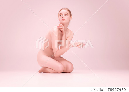 Young naked beautiful girl looking at camera isolated on pink studio background. Concept of beauty, purity, tenderness and grace. Young naked beautiful girl looking at camera isolated on pink studio background. Concept of beauty, purity, tenderness and grace. 78997970