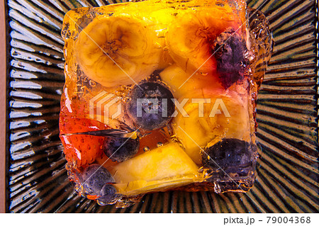 Jelly from different fruits and berries on a square saucer. Dessert. Jelly from different fruits and berries on a square saucer. Dessert. 79004368