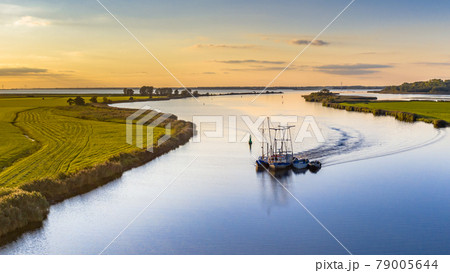 Aerial view of river with ship at sunset Aerial view of river with ship at sunset 79005644