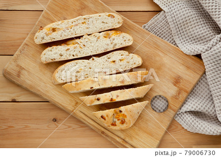 Loaf of organic bread on wooden background with cheese and ham. Fresh whole grain bread. Natural food concept. 79006730
