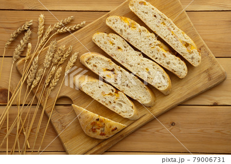 Loaf of organic bread on wooden background with cheese and ham. Fresh whole grain bread. Natural food concept. 79006731