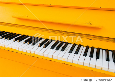 yellow vintage piano, closeup view yellow vintage piano, closeup view 79009482