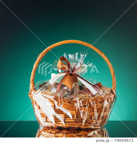 gift basket on emerald background gift basket on emerald background 79009872