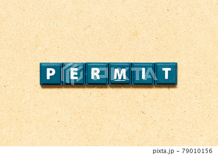 Tile alphabet letter in word permit on wood background Tile alphabet letter in word permit on wood background 79010156