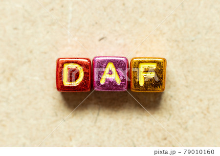 Metallic color alphabet letter block in word DAF (Abbreviation of Delivered at frontier) on wood background 79010160