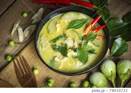 Chicken green curry Thai food on soup bowl with ingredient vegetable herbs and spices pepper chili, Traditional green curry chicken cuisine asian food. Top view Chicken green curry Thai food on soup bowl with ingredient vegetable herbs and spices pepper chili, Traditional green curry chicken cuisine asian food. Top view 79010722