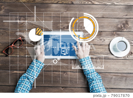 Business workplace with tablet device coffee cup and media graphs and diagrams Business workplace with tablet device coffee cup and media graphs and diagrams 79017870