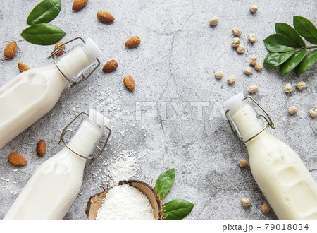Alternative types of vegan milks in glass bottles Alternative types of vegan milks in glass bottles 79018034