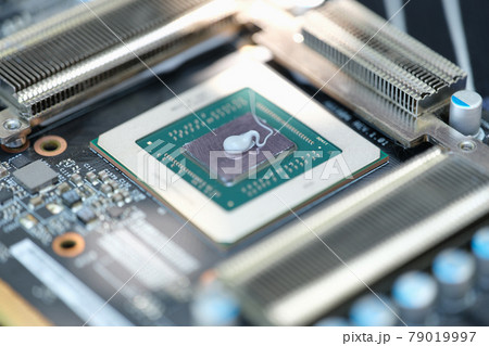 Thermal paste lying on microchip for video card closeup 79019997
