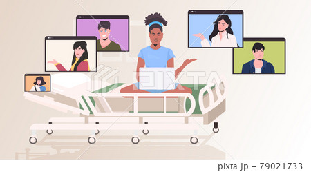 pregnant woman in hospital bed chatting with friends in web browser windows during video call online meeting 79021733