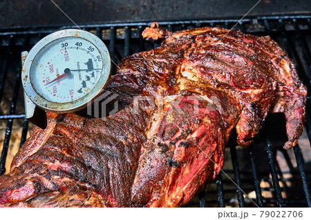 Roast lamb with inserted meat thermometer on the grill rack Roast lamb with inserted meat thermometer on the grill rack 79022706