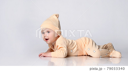 adorable laughing little kid in a yellow cotton adorable laughing little kid in a yellow cotton 79033340