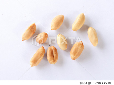 peeled peanuts scattered on a white background peeled peanuts scattered on a white background 79033546