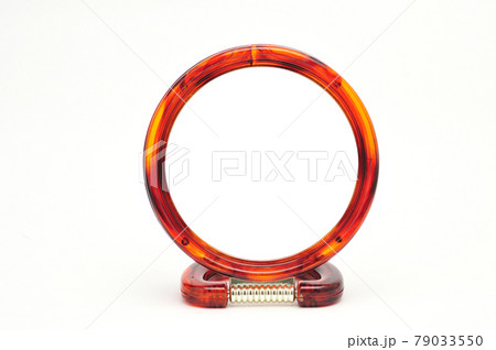 Table mirror in amber frame on a white background 79033550