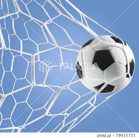 Goal of a soccer ball in the goal net on a blue background Goal of a soccer ball in the goal net on a blue background 79035755