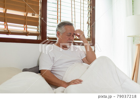 Asian Elderly senior man white hairs headache and migraine so pain and illness,Stress senior man sit on bed at home alone,unhappy elderly touch on head serious and tried,Unhappiness Elderly concept Asian Elderly senior man white hairs headache and migraine so pain and illness,Stress senior man sit on bed at home alone,unhappy elderly touch on head serious and tried,Unhappiness Elderly concept 79037218